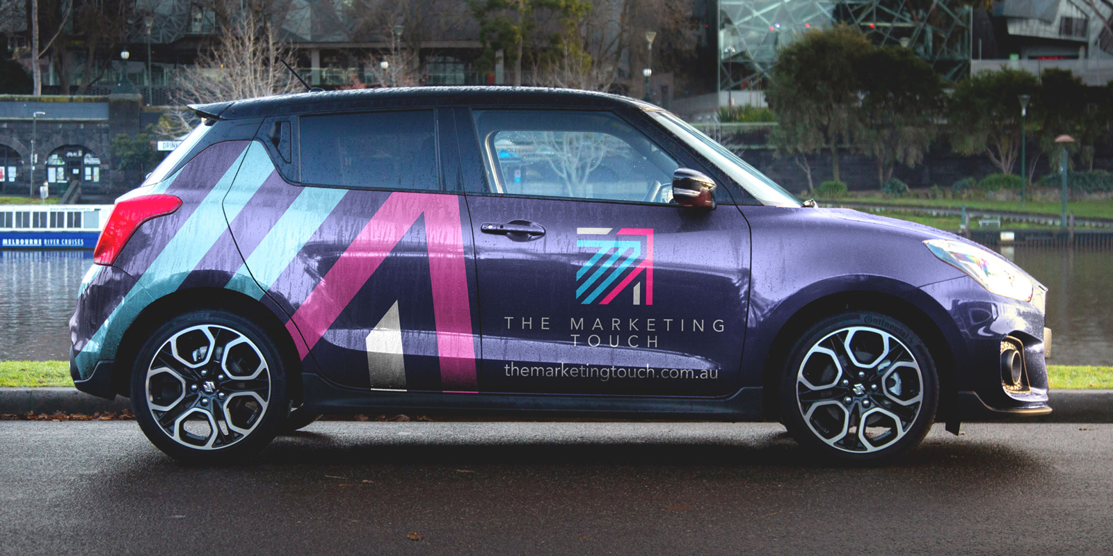 Photo of a Suzuki Swift with vehicle graphics for The Marketing Touch
